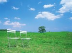 Two Empty Chairs in a Field